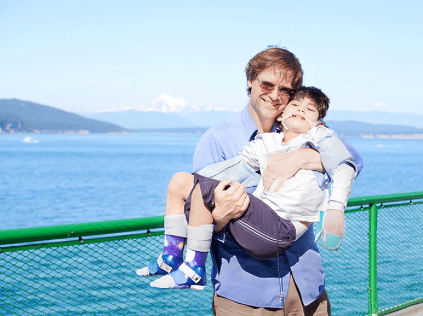 Father holding child with special needs