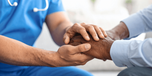 Doctor Holding Patient Hand Image